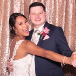 Married couple striking a dance pose inside a photo booth