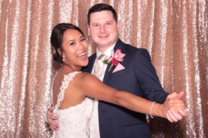 Married couple striking a dance pose inside a photo booth